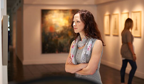 Art collector examining a painting in detail